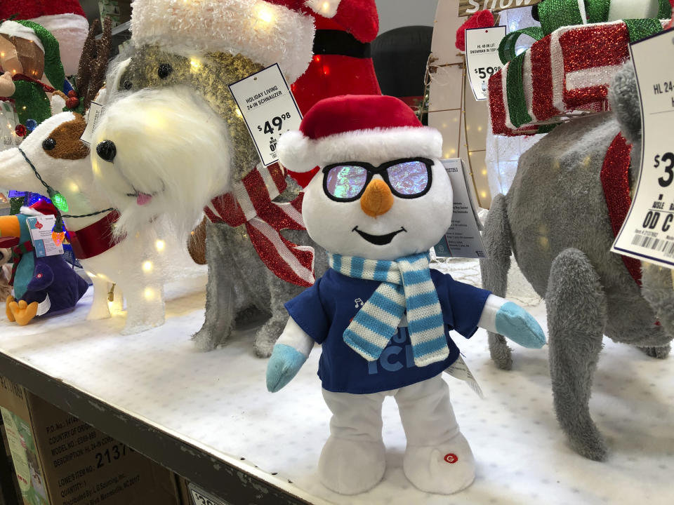 Holiday knick-knacks stand are displayed for Christmas shoppers Friday, Oct. 2, 2020, at a Lowes store in Northglenn, Colo. Add last-minute holiday shopping to the list of time-honored traditions being upended by the coronavirus pandemic. Retailers are kicking off the holiday season earlier than ever this year in hopes of avoiding big in-store crowds and shipping bottlenecks in November and December. (AP Photo/David Zalubowski)