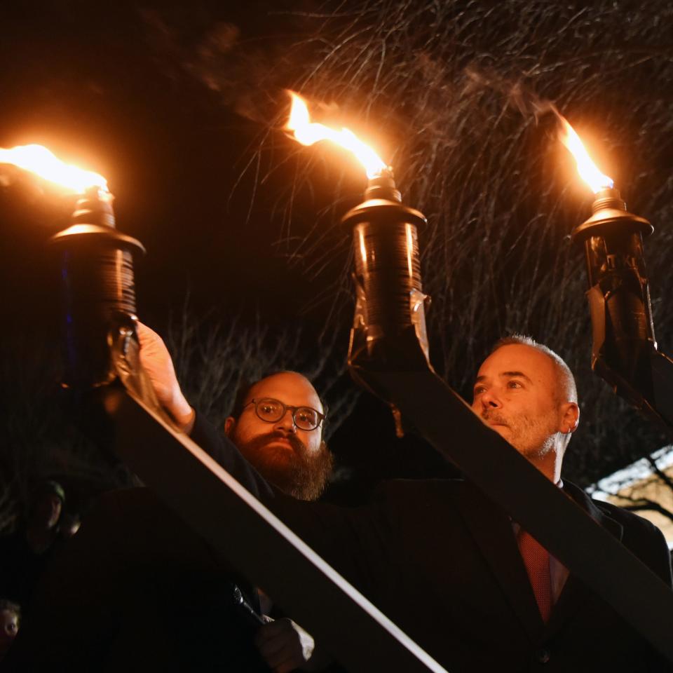 Rabbi Yosef Orenstein of Valley Chabad in Woodcliff Lake, left, lighting a menorah with Allendale Mayor Ari Bernstein in 2018. Orenstein said Holocaust survivors provide "a message of hope in a world that seems overwhelmed by darkness."