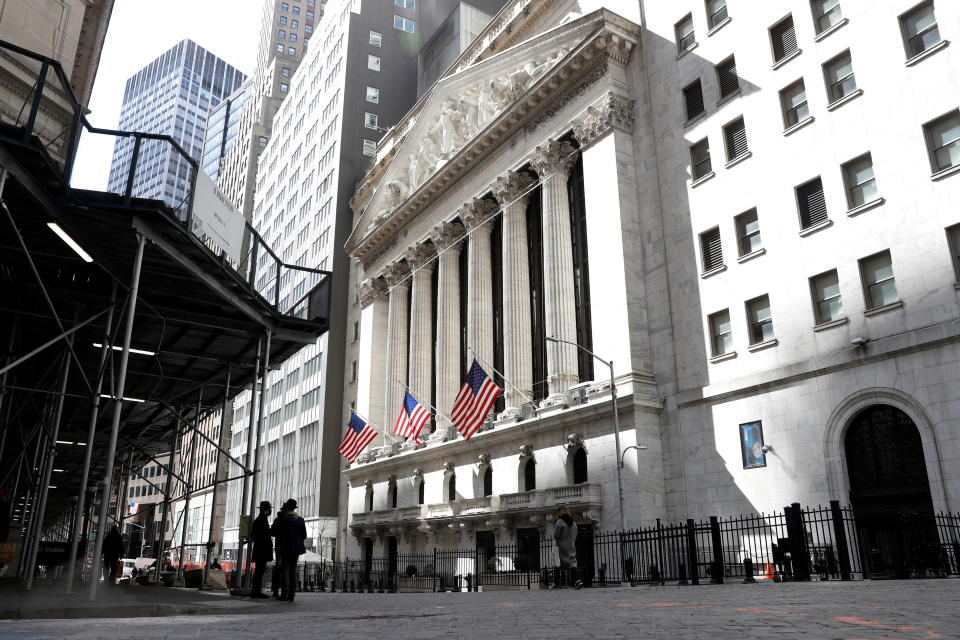 People are seen on Wall St. outside the New York Stock Exchange (NYSE) in New York City, U.S., March 19, 2021.  REUTERS/Brendan McDermid