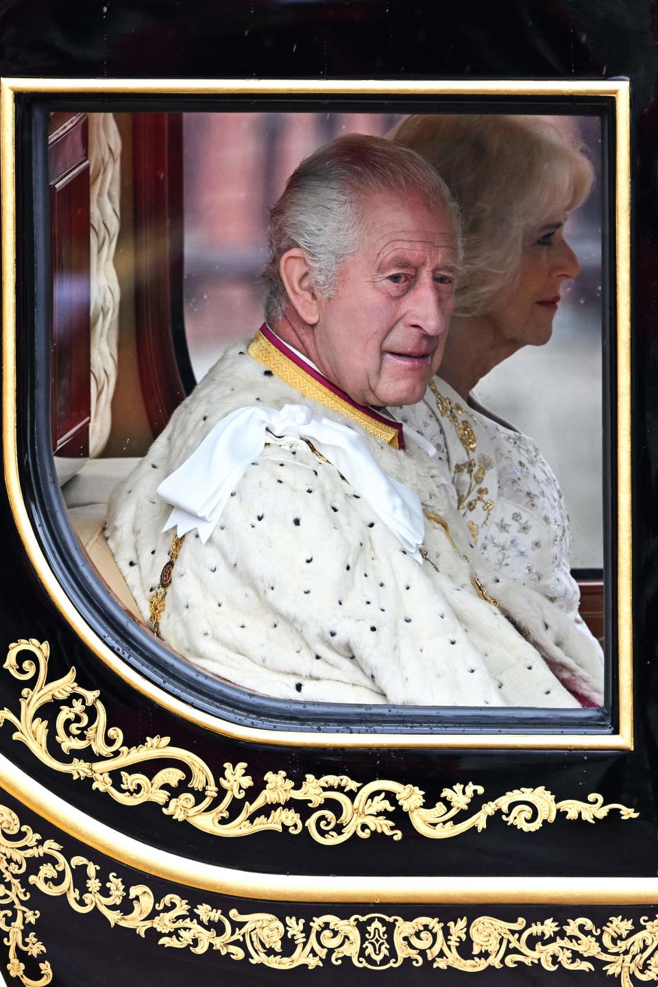 Britain's King Charles III and Britain's Camilla, Queen Consort begin their journey in the Diamond Jubilee State Coach in the "King's Procession," a journey from Buckingham Palace to Westminster Abbey, ahead of their coronations.