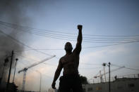 FILE A protester raises his fist during a demonstration against police violence and racial injustice, in Paris, Tuesday, June 2, 2020. France is inducting Missouri-born cabaret dancer Josephine Baker, who was also a French World War II spy and civil rights activist – into its Pantheon. She is the first Black woman honored in the final resting place of France’s most revered luminaries. On the surface, it’s a powerful message against racism, bt by choosing a U.S.-born figure -- entertainer Josephine Baker – critics say France is continuing a long tradition of decrying racism abroad while obscuring it at home. (AP Photo/Rafael Yaghobzadeh, File)