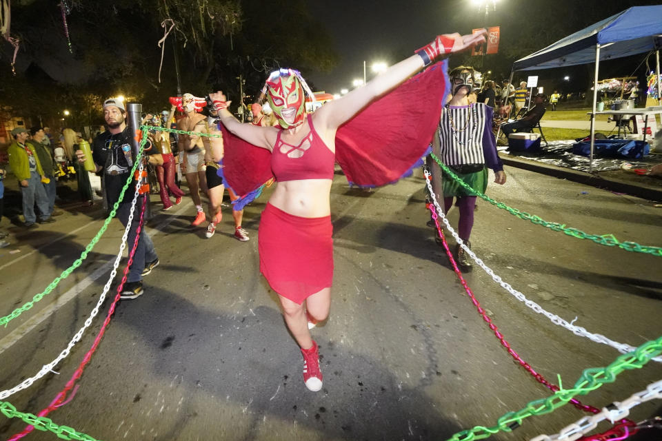 FILE - Members of the Lucha Krewe perform as the Krewe of Druids Mardi Gras parade rolls through New Orleans, Wednesday, Feb. 15, 2023. The countdown to Mardi Gras begins Saturday, Jan. 6, 2024, in New Orleans as Carnival season kicks off with dozens of costumed revelers and a brass band set to crowd onto a streetcar for the Phunny Phorty Phellows' nighttime ride down historic St. Charles Avenue. Meanwhile, a walking club in the French Quarter will march in its annual procession honoring Joan of Arc. (AP Photo/Gerald Herbert, File)