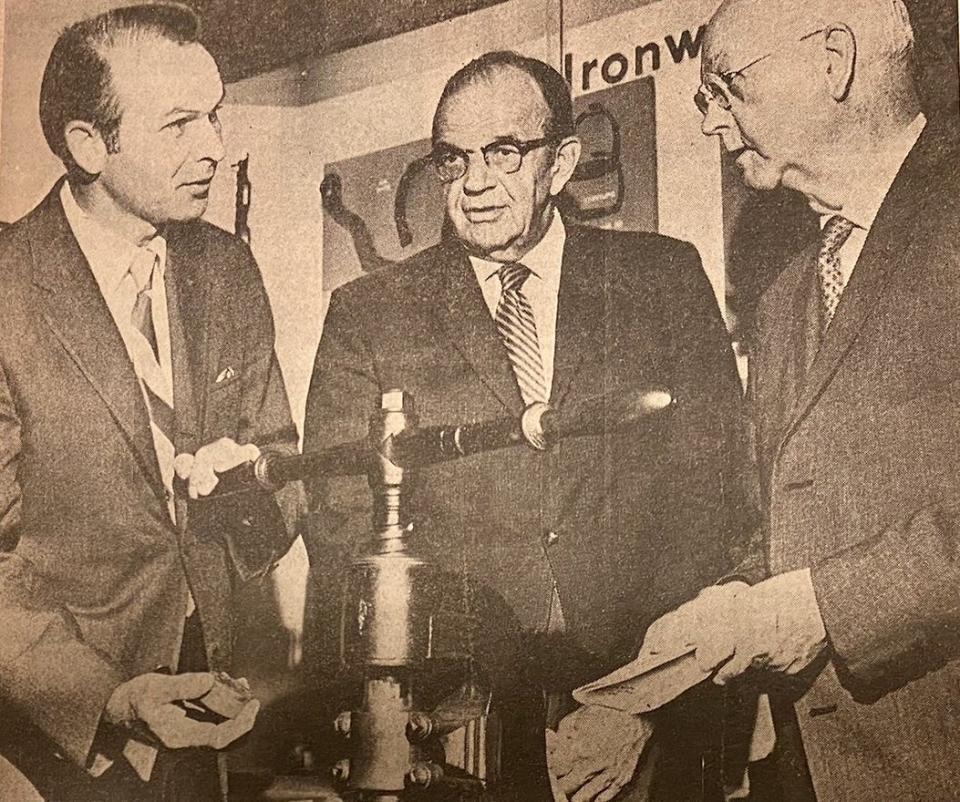 Vaughn Baker, left, who was then acting Washington County circuit clerk, demonstrates a hand press used to imprint a Washington County Circuit Court seal on documents. He was donating it to the Washington County Historical Society. Next to Baker is Richard Prather, curator of the Hager House Museum. At right is Simms Jamieson, president of the historical society.