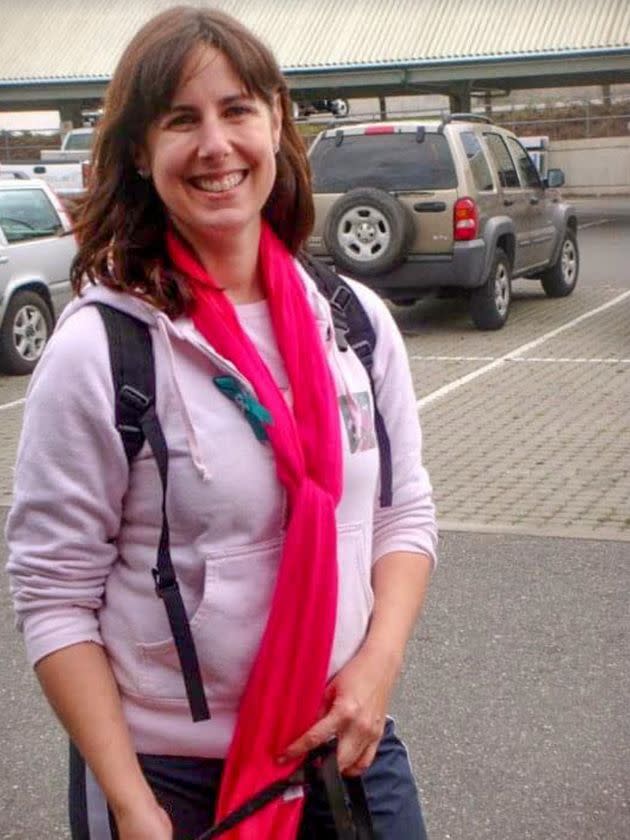 The author learned the symptoms of ovarian cancer a decade before her own diagnosis. In this 2010 photo taken at a Cancer Walk, she's wearing pink for breast cancer awareness and a small teal ribbon signifying ovarian cancer. (Photo: Courtesy of Kari Neumeyer)