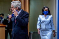 Attorney General Merrick Garland and Assistant Attorney General for Civil Rights Kristen Clarke, right, arrives for a news conference at the Department of Justice in Washington, Thursday, Aug. 5, 2021, to announce that the Department of Justice is opening an investigation into the city of Phoenix and the Phoenix Police Department. (AP Photo/Andrew Harnik)