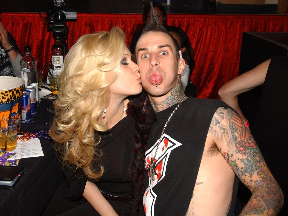 Shanna Moakler kissing Travis Barker's cheek.