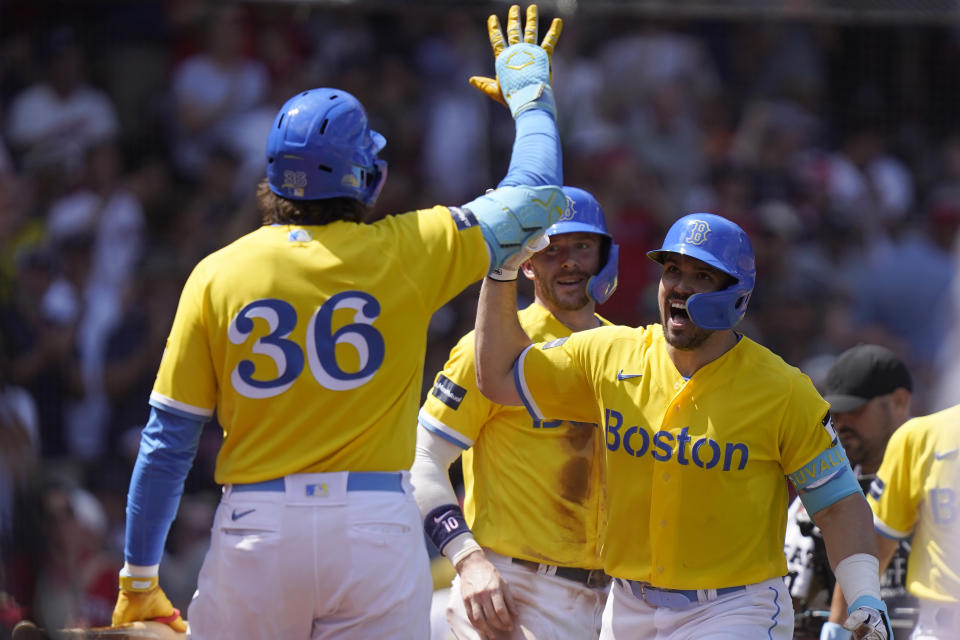 Boston Red Sox's Adam Duvall, right, celebrates with Triston Casas (36) and Trevor Story, back center, after hitting a three-run home run in the fifth inning of a baseball game against the Detroit Tigers, Sunday, Aug. 13, 2023, in Boston. (AP Photo/Steven Senne)