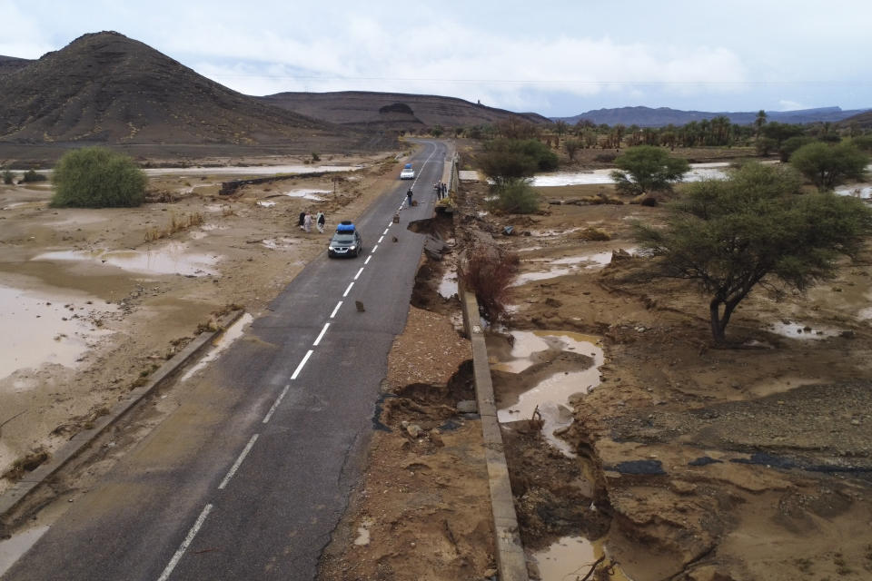 Cars drive through a road that was damaged by floods caused by heavy rainfall in Tazarine, Zagora, southern Morocco, Sunday, Sept. 8, 2024. Moroccan authorities say exceptional weather has killed at least 11 people and destroyed homes in southern Morocco. (AP Photo)