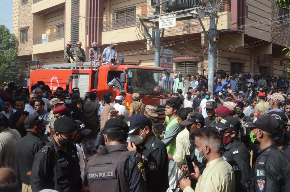 KARACHI, PAKISTAN, MAY 22: Pakistani people arrive at the site of a passenger plane crash in Karachi, Pakistan, May 22, 2020. A Pakistani passenger plane with at least 100 people on board crashed in a residential area in the Pakistani city of Karachi on Friday, the country's civil aviation agency said. (Photo by H.KHAN/Anadolu Agency via Getty Images)