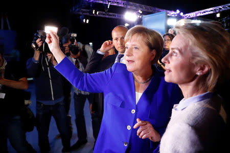 German Chancellor Angela Merkel of the Christian Democratic Union (CDU) speaks to German defence Minister Ursula von der Leyen after the TV debate with her challenger Germany's Social Democratic Party SPD candidate for chancellor Martin Schulz in Berlin, Germany, September 3, 2017. REUTERS/Fabrizio Bensch