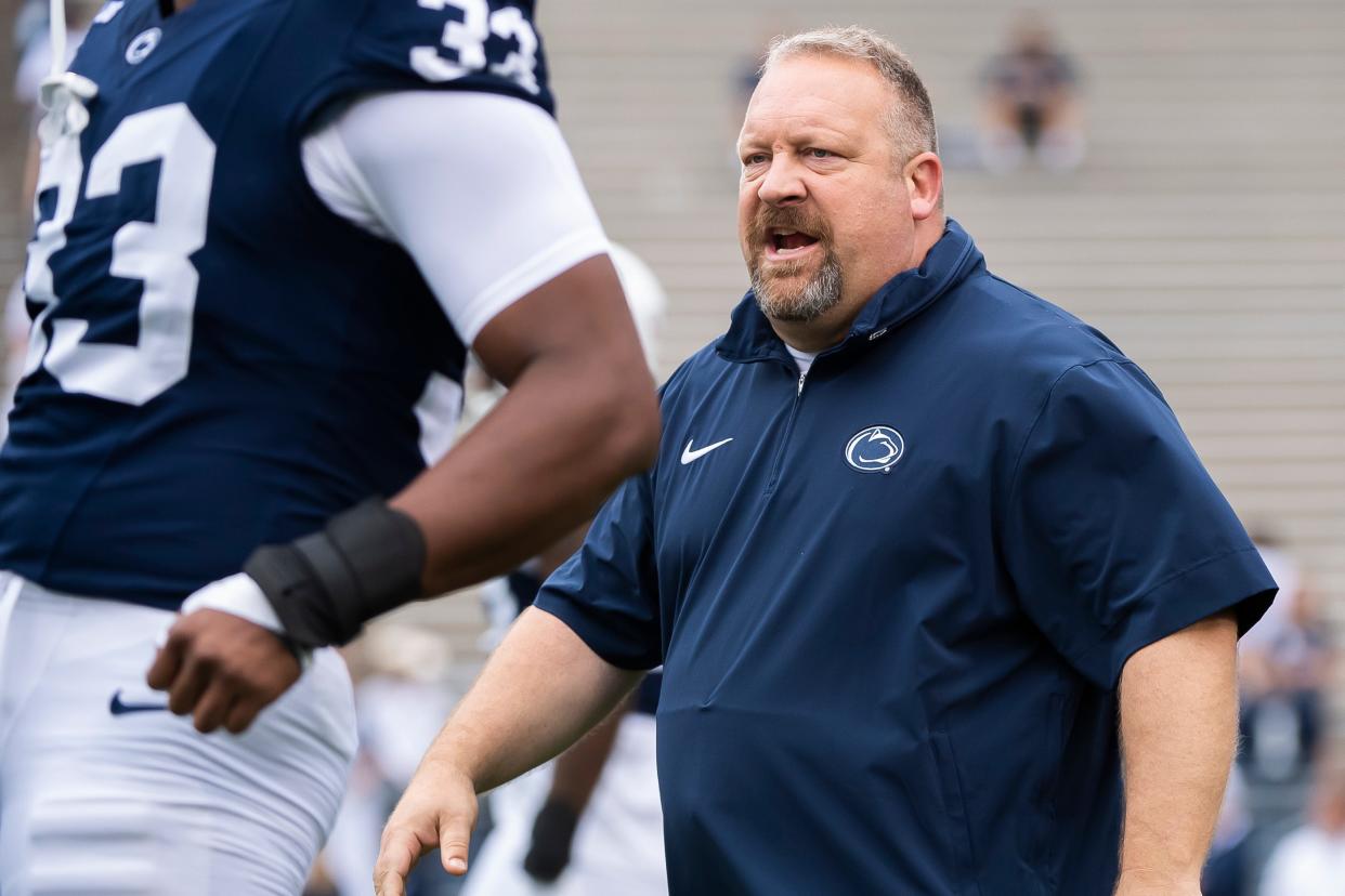 Former Penn State special teams coordinator Stacy Collins makes his way between players during team warmups before an NCAA football game against Indiana Saturday, Oct. 28, 2023, in State College, Pa. The Nittany Lions won, 33-24.