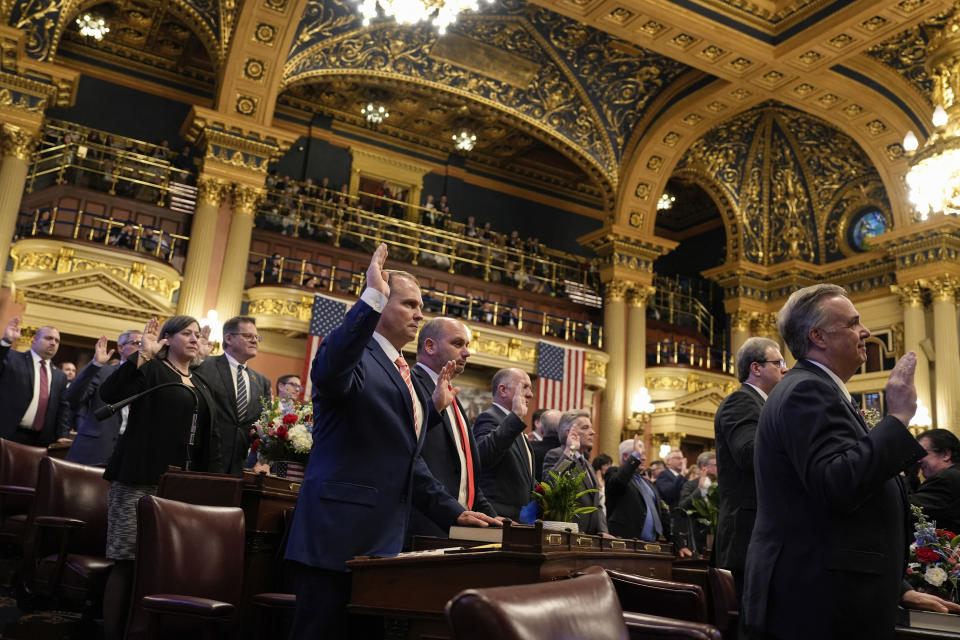 Legislators of the Pennsylvania House of Representatives are sworn-in, Tuesday, Jan. 3, 2023, at the state Capitol in Harrisburg, Pa. The ceremony marks the convening of the 2023-2024 legislative session of the General Assembly of Pennsylvania. (AP Photo/Matt Smith)