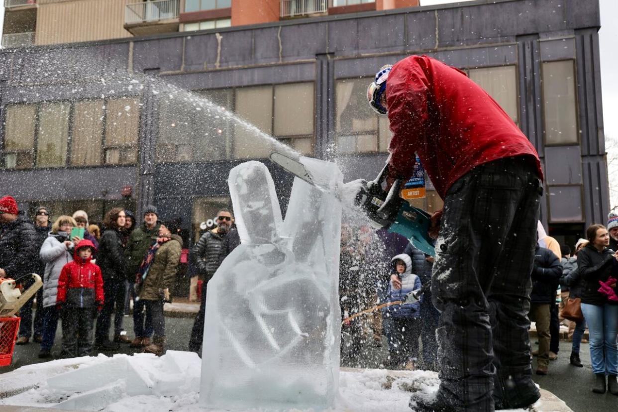 People gathered to watch sculptures emerge from giant blocks of ice. (Jeorge Sadi/CBC - image credit)