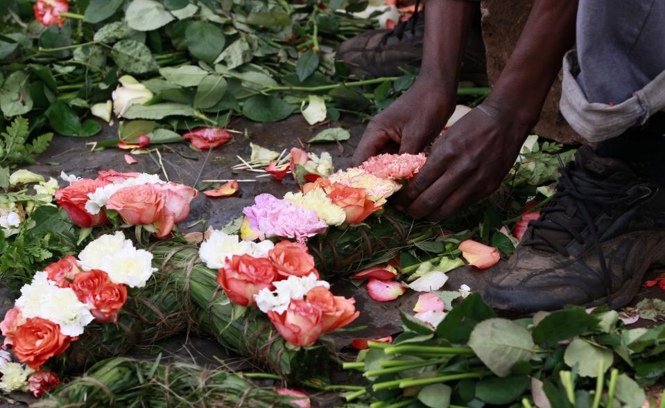 Trader prepares flowers in the shape of a cross for sale outside the City Mortuary, for the victims who were killed during the attack at the Westgate Shopping Centre in Nairobi