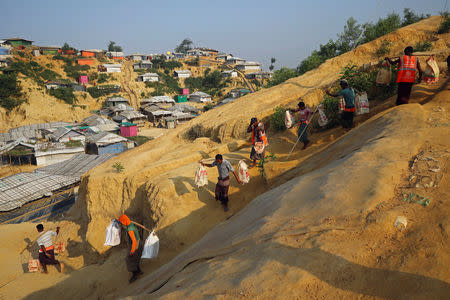 Rohingya refugees carry bricks to a construction site at the Balukhali camp in Cox's Bazar, Bangladesh, April 8, 2019. REUTERS/Mohammad Ponir Hossain