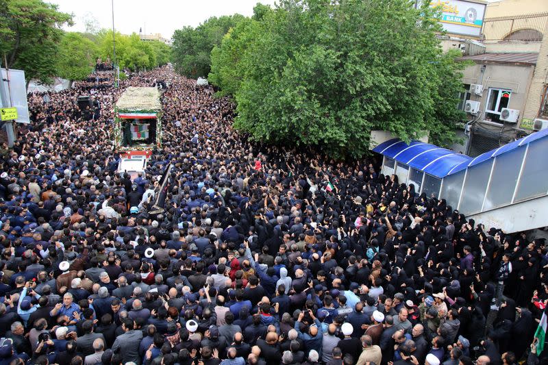 People attend a funeral ceremony for the late Iranian President Ebrahim Raisi in Tabriz