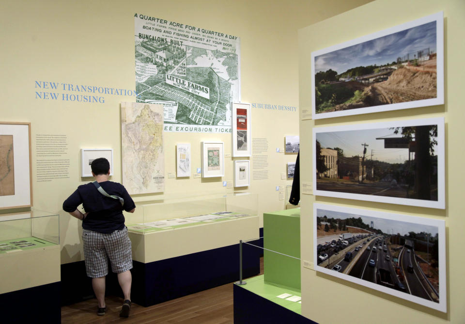 In this Thursday, Sept. 13, 2012 photo, a woman browses the exhibit "From Farm to City: Staten Island 1661-2012" at the City of New York Museum in New York. It is known as New York City's greenest borough _ and also as its forgotten borough. Aside from the Staten Island Ferry, the Verrazzano Bridge and maybe the Fresh Kills landfill, few people know anything about Staten Island and its rich history and influence on the development of the rest of the city. Now, this new exhibition aims to rectify that. (AP Photo/Seth Wenig)
