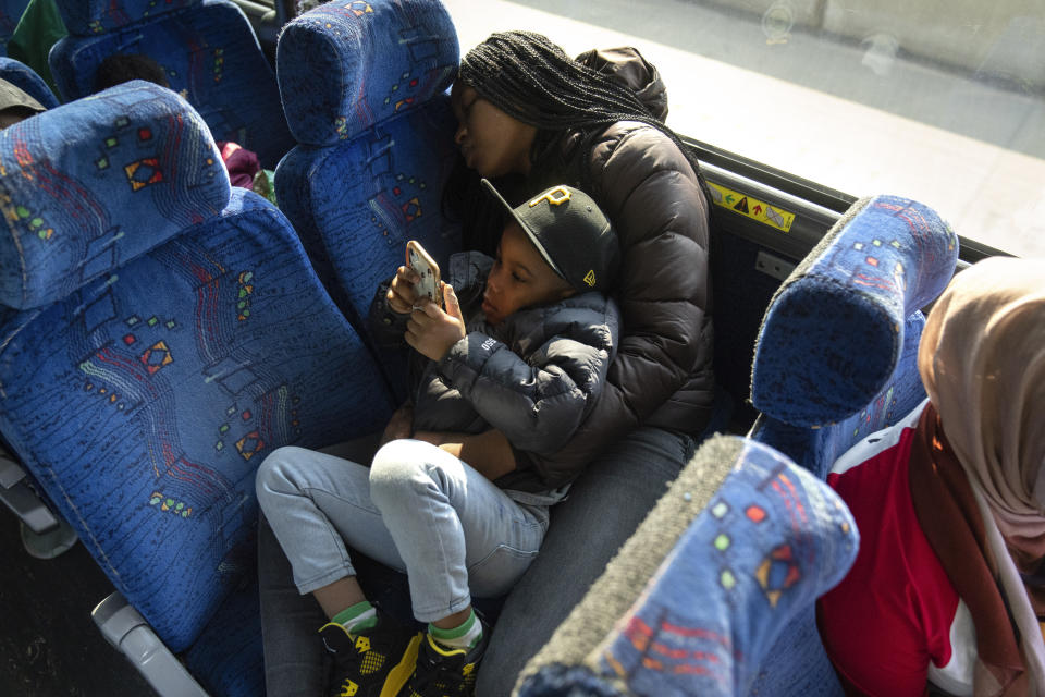 Jada Lesure, 23, holds her 4-year-old son Davi Stewart Roberts, 4, during a three-hour bus ride to Logan Correctional Center in downstate Illinois to visit her incarcerated mother Erika Ray, his grandmother, Saturday, May 20, 2023, in Illinois. Rare programs like the Reunification Ride, a donation-dependent initiative that buses prisoners' family members from Chicago to Illinois' largest women's prison every month so they can spend time with their mothers and grandmothers, are a crucial lifeline for families, prisoners say. (AP Photo/Erin Hooley)