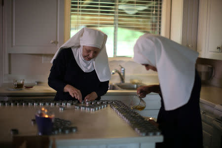 California "weed nun" Christine Meeusen, 57, who goes by the name Sister Kate (L), and India Delgado, who goes by the name Sister Eevee, pour CBD salve made from hemp at Sisters of the Valley near Merced, California, U.S., April 18, 2017. REUTERS/Lucy Nicholson