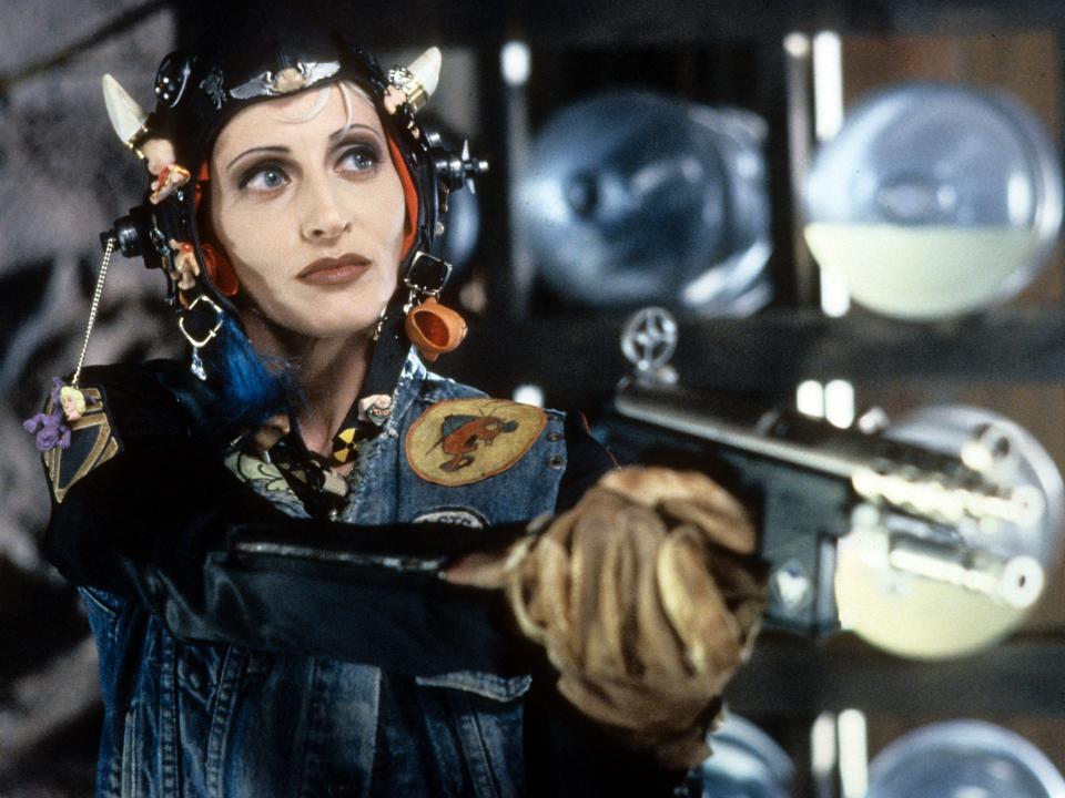 Lori Petty wearing bizarre head gear while holding a gun in a scene from the film 'Tank Girl', 1995