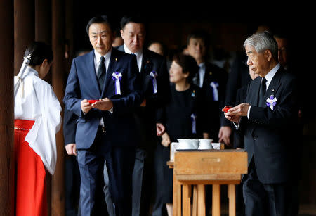 A group of lawmakers including Japan's ruling Liberal Democratic Party (LDP) lawmaker Hidehisa Otsuji (R) sip sake as a ritual after offering prayers for the war dead at the Yasukuni Shrine in Tokyo, Japan, August 15, 2017, to mark the 72nd anniversary of Japan's surrender in World War Two. REUTERS/Issei Kato