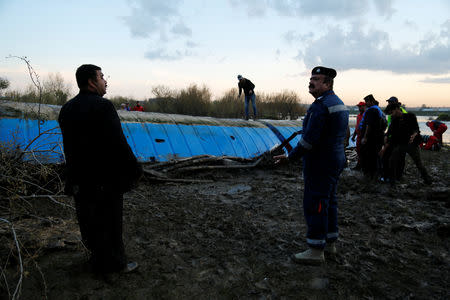 Members of the Iraqi Civil Defence work near the ferry which sank in the Tigris River in Mosul, Iraq March, 23, 2019. Picture taken March 23, 2019. REUTERS/Stringer