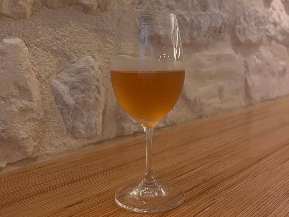 Orange wine in a glass at Folderol Paris