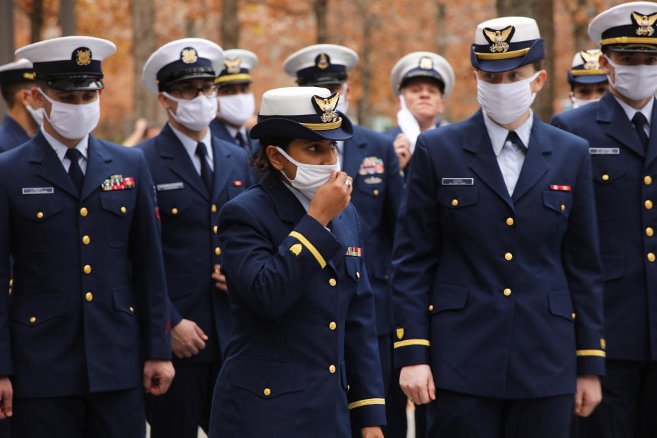 NEW YORK CITY - NOVEMBER 11: Members of the U.S. Coast Guard honor veterans killed in the attacks on September 11 at the memorial at Ground Zero on Veterans Day on November 11, 2020 in New York City. The annual parade in New York, which draws thousands of veterans and spectators from around the country and world, was held as a virtual event this year due to COVID-19. Despite the pandemic restrictions, veterans found numerous ways to honor those that served their country in the armed forces.   (Photo by Spencer Platt/Getty Images)