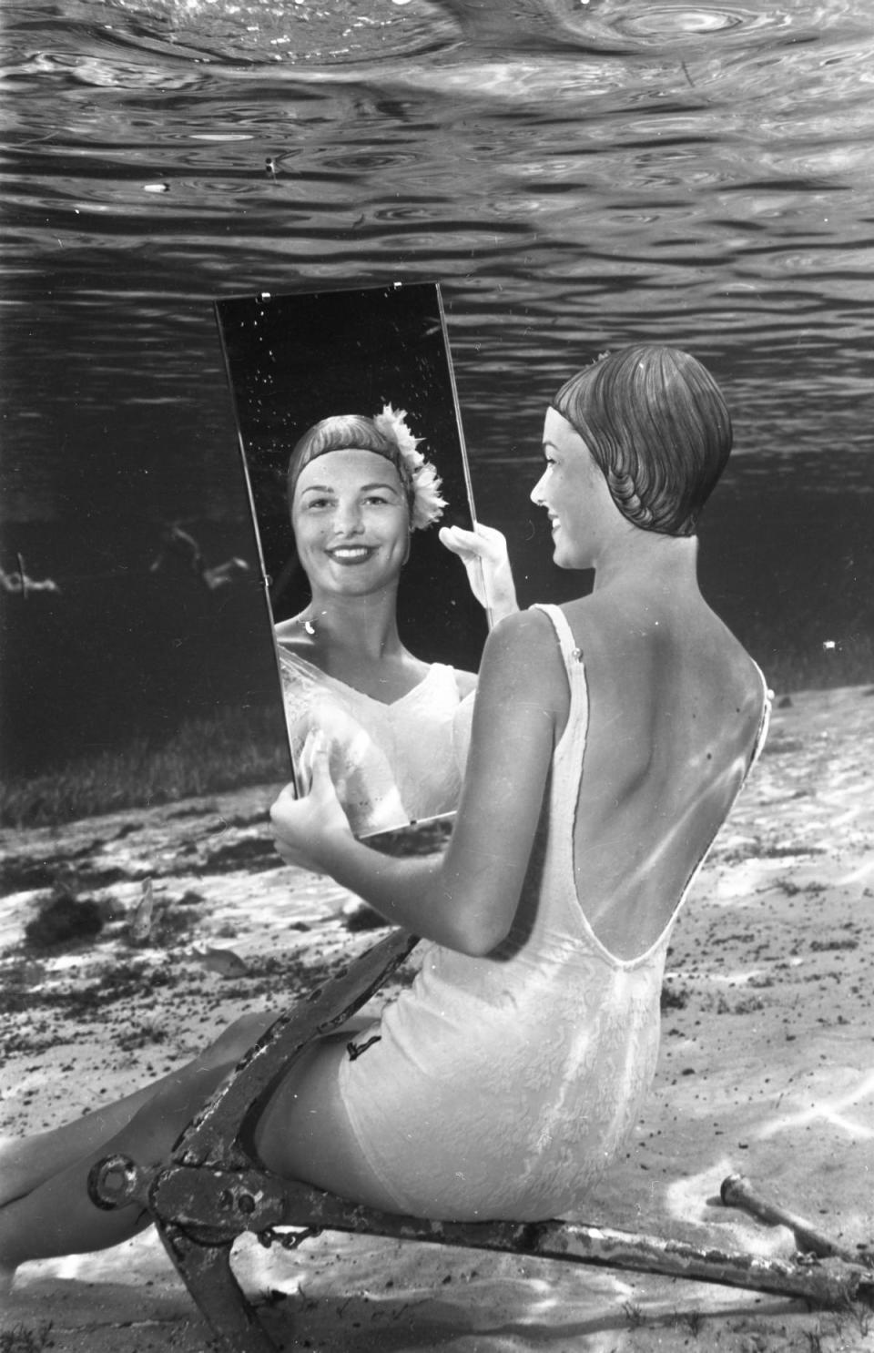 A model smiles at her reflection under water at Silver Springs near Ocala in this photo from Bruce Mozert from around 1950.