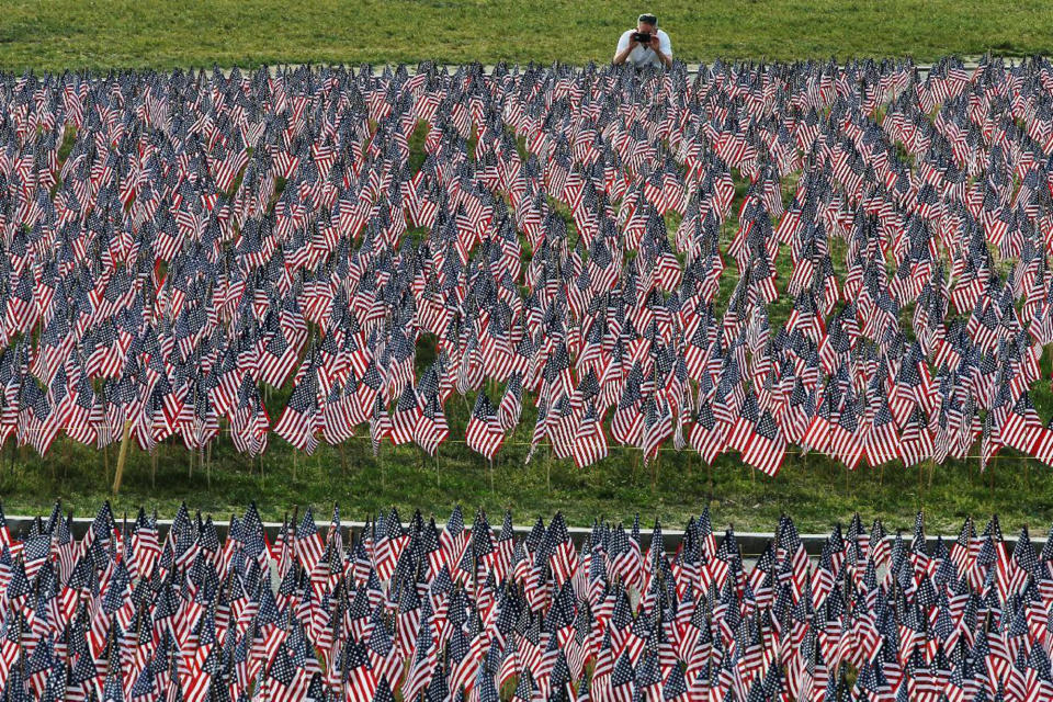 <p>A man photographs a field of United States flags displayed by the Massachusetts Military Heroes Fund on the Boston Common in Boston, May 26, 2016, ahead of the Memorial Day holiday on May 30. The 37,000 U.S. flags are planted in memory of every fallen Massachusetts service member from the Revolutionary War to the present. (Reuters/Brian Snyder) </p>