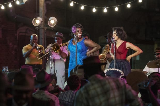 Ruby Baptiste (<em>(Wunmi Mosaku, in the blue dress) and Leti Lewis (Jurnee Smollett, in red).</em>