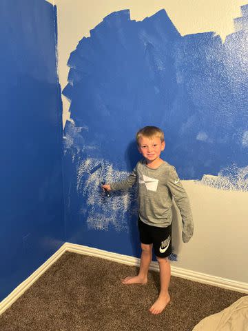 <p>Courtesy Heather Beck</p> Abel Beck paints the walls of his family's new home