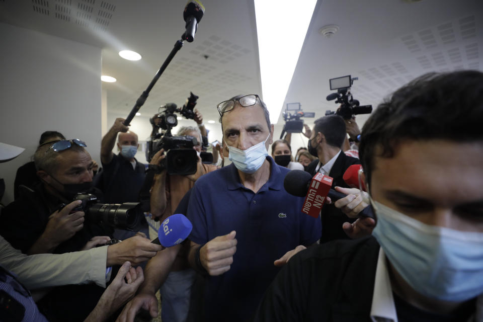 Shmulik Peleg, maternal grandfather of Eitan Biran, who survived a cable car crash in Italy that killed his immediate family, leaves court in Tel Aviv on Thursday, Sept. 23, 2021 for a hearing on charges of kidnapping his grandson. The boy's parents and younger sibling were among 14 killed in May when a cable car slammed into a mountainside in northern Italy. He is now the focus of a custody battle between his maternal grandparents in Israel and his paternal relatives in Italy. (AP Photo/Sebastian Scheiner)