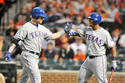 Texas Rangers' Josh Hamilton (L) celebrates with teammate Adrian Beltre after hitting a two-run home run in the third inning during the game against the Baltimore Orioles on May 8. Hamilton smacked four two-run homers and finished the game batting five-for-five