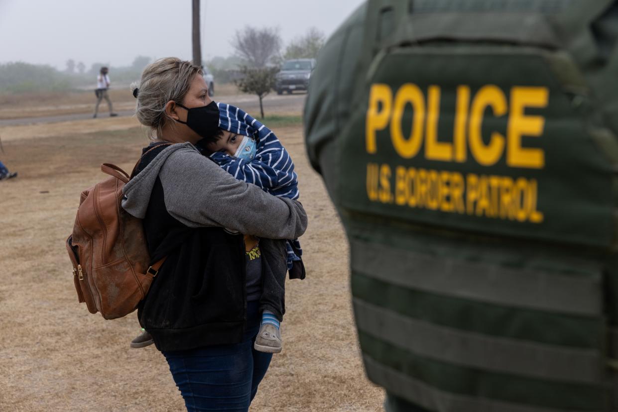 U.S. Border Patrol agent and immigrants on April 10, 2021, in La Joya, Texas.