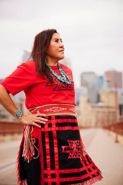 Navajo woman in red clothing and dark hair