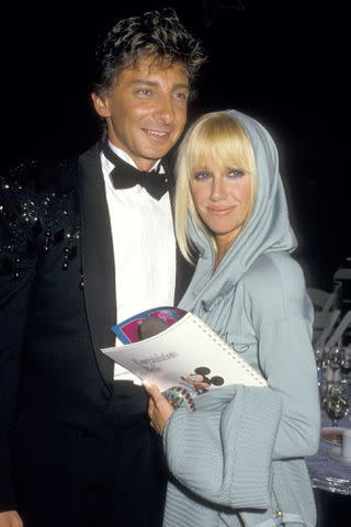 <p>Denise Truscello/Getty</p> Barry Manilow and Suzanne Somers in 1986