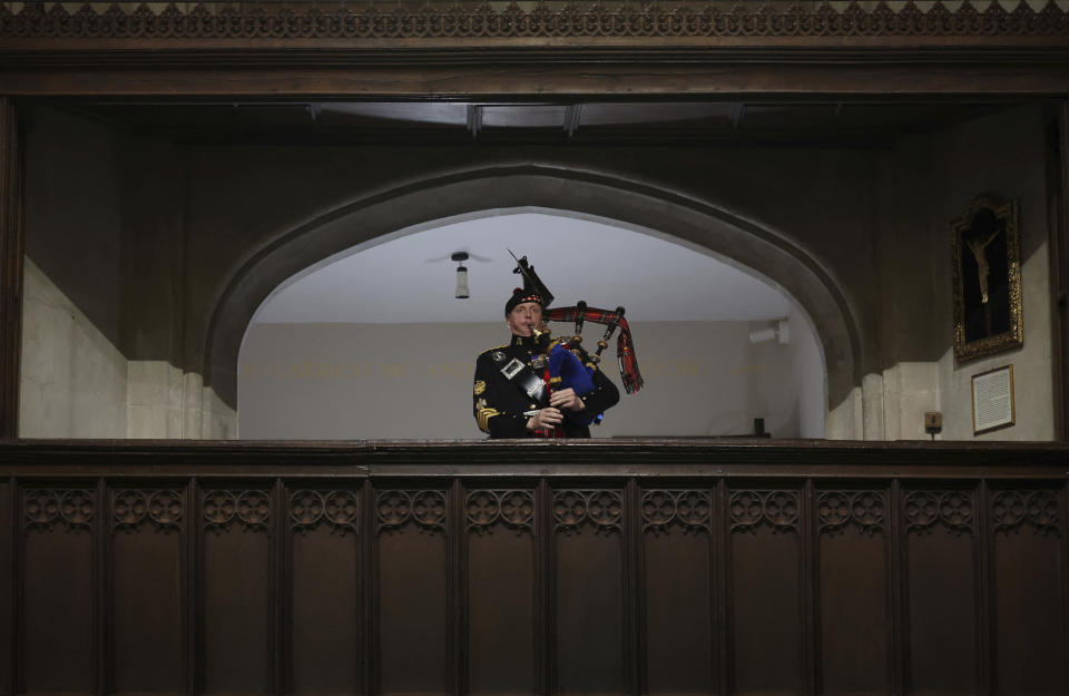 A piper plays during the funeral of Britain's Queen Elizabeth II, in London, Monday Sept. 19, 2022. (Phil Noble/Pool Photo via AP)