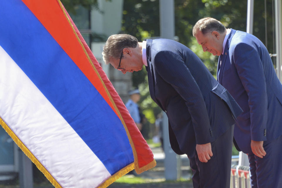 Serbian President Aleksandar Vucic, center, reviews the honour guard with Bosnian Serb leader Milorad Dodik during a welcome ceremony in Banja Luka, northern Bosnia, Friday, Aug. 4, 2023. Serbia will ignore U.S. sanctions recently imposed on top Bosnian Serb officials for undermining a 1995 peace agreement that ended a war that left more than 100,000 dead and millions homeless, the Serbian president said Friday. (AP Photo/Radivoje Pavicic)