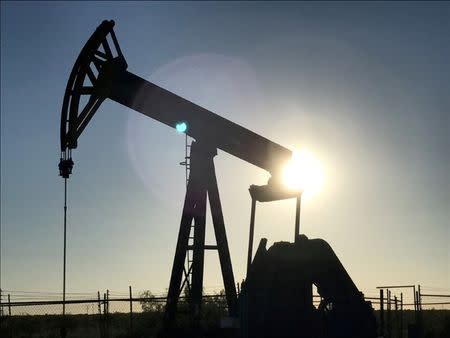 FILE PHOTO: An oil pump is seen operating in the Permian Basin near Midland, Texas, U.S., May 3, 2017. REUTERS/Ernest Scheyder/File Photo