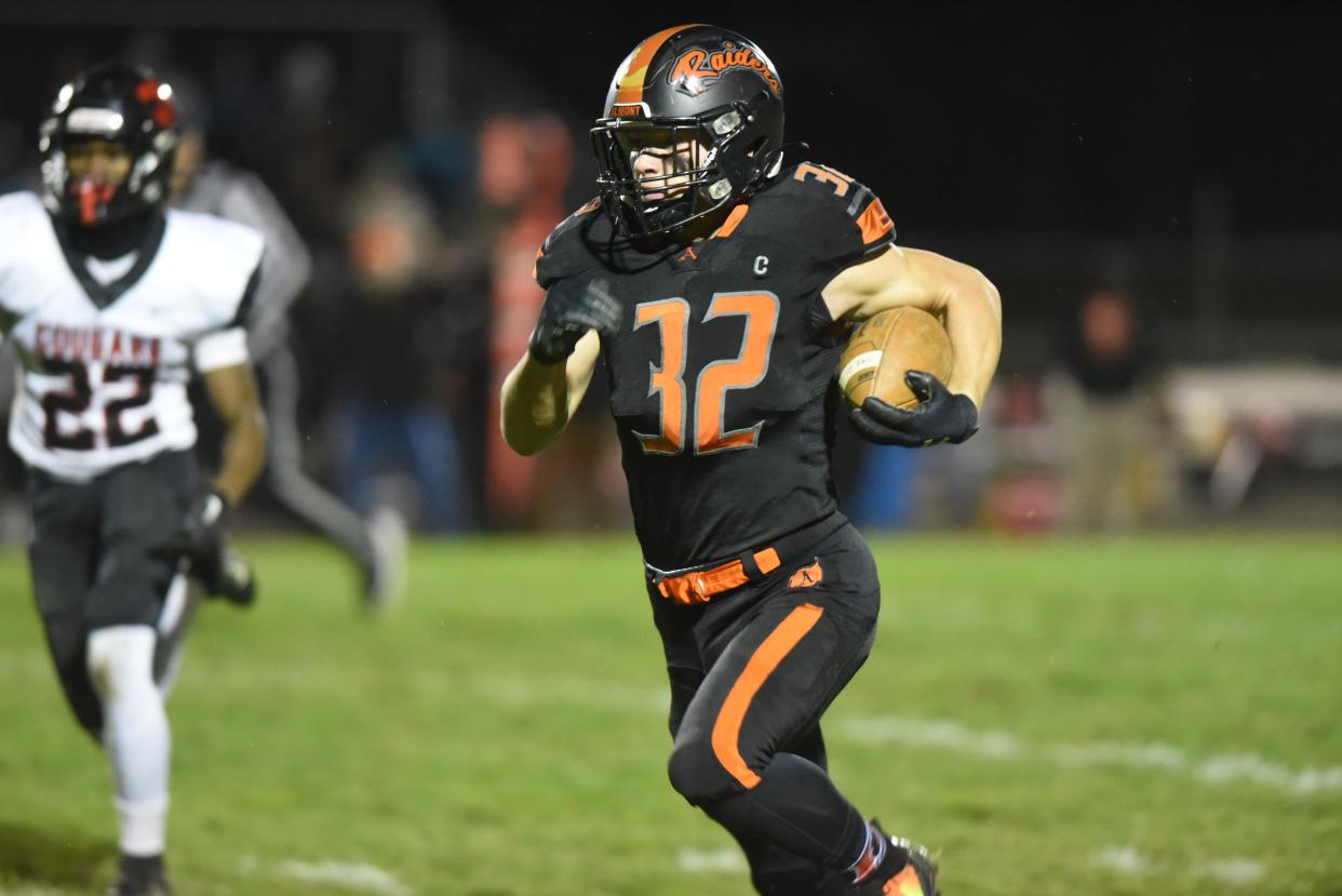 Almont's Chase Battani carries the ball during a game earlier this season.