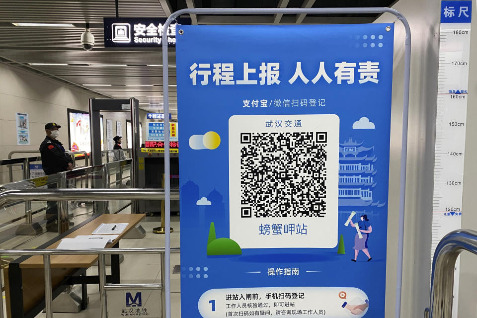 In this April 1, 2020, photo, a QR code is set up for passengers to check their green pass status at a subway station in Wuhan in central China's Hubei province. Life in China post-coronavirus outbreak is ruled by a green symbol on a smartphone screen. Green signifies the "health code" that says the user is symptom-free. It is required to board a subway, check into a hotel or enter Wuhan, the city where the global pandemic began. (AP Photo/Ng Han Guan)