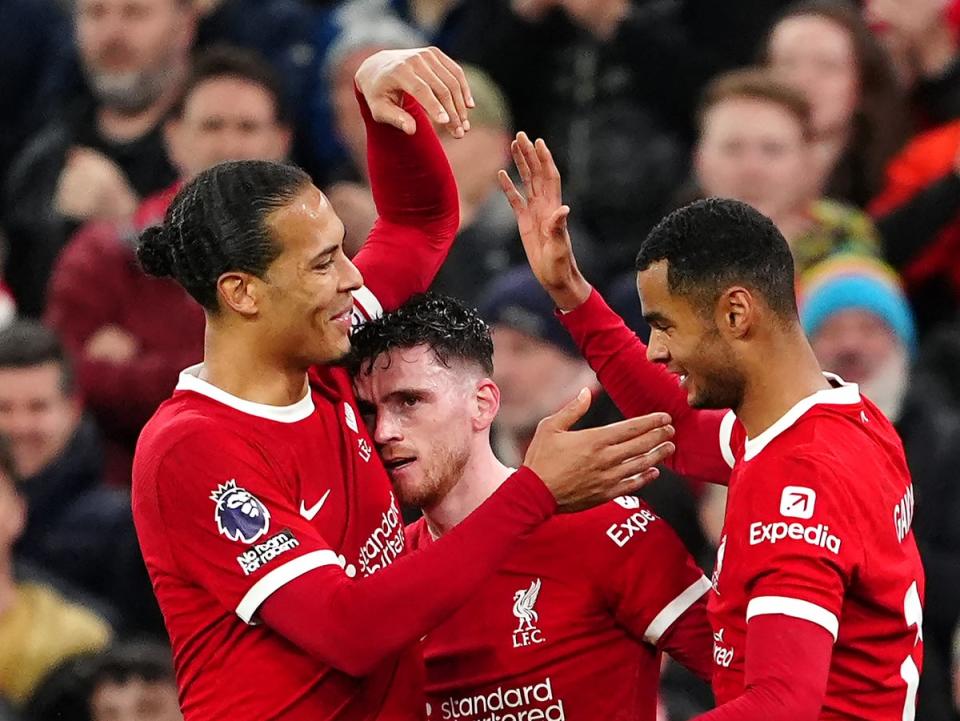Virgil van Dijk, Andy Robertson and Cody Gakpo celebrate Liverpool’s third goal (Peter Byrne/PA Wire)