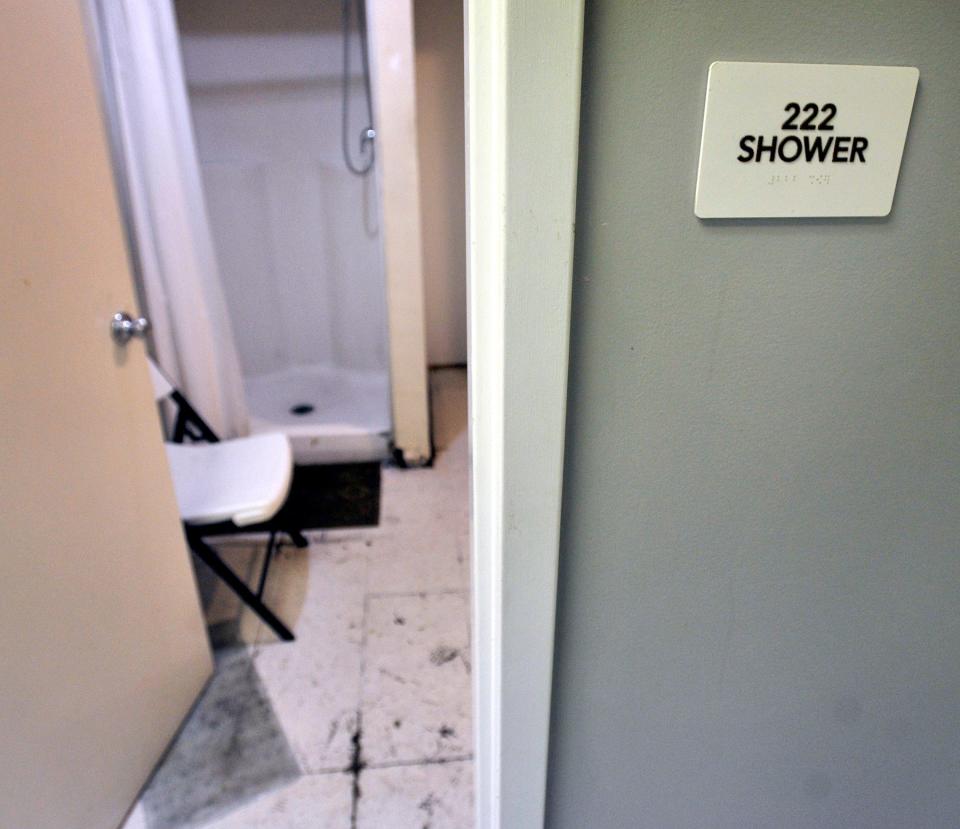 The shower room at Dover Interfaith Mission shows, what appears to be, black mold on the floor.