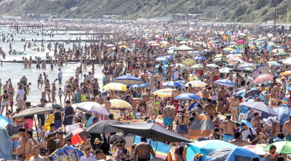 BOUNEMOUTH,ENGLAND - JUNE 24: Members of the public enjoy the sunshine on Bournemouth Beach on June 24,2020 in Bournemouth,England.The UK is experiencing a summer heatwave, with temperatures in many parts of the country expected to rise above 30C and weather warnings in place for thunderstorms at the end of the week. (Photo by Chris Gorman/Getty Images)