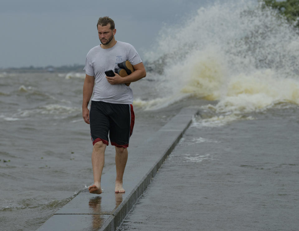 Wesley Vinson wades through storm surge from Lake Pontchartrain on Lakeshore Drive in Mandeville, La., as Hurricane Barry approaches Saturday, July 13, 2019. (Photo: Matthew Hinton/AP)