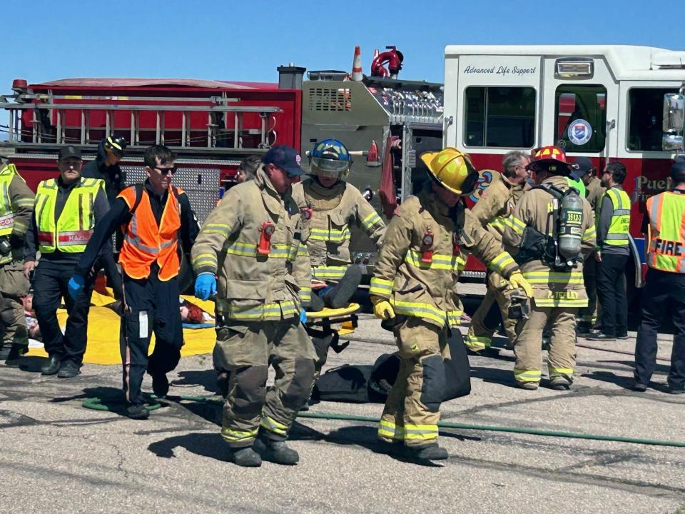 Pueblo firefighters carry a simulated victim to a waiting helicopter at Pueblo's first post-CSEPP MCI exercise.