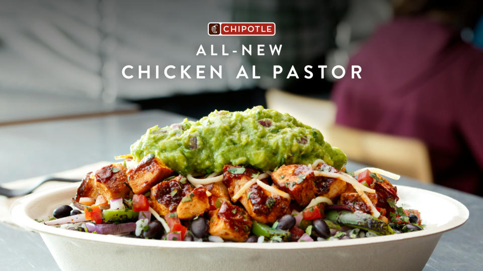 A Chipotle burrito bowl with chicken al pastor, cheese, and guacamole on top is shown in this advertisement.