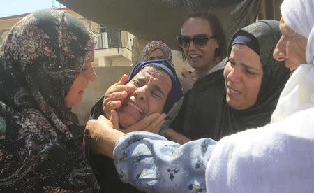 Relatives of Palestinian Saad Dawabsheh mourn during his funeral in in Duma village near the West Bank city of Nablus August 8, 2015. REUTERS/Abed Omar Qusini/Files