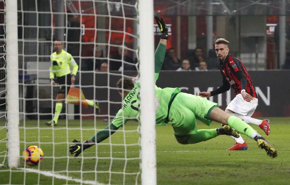 AC Milan's Samuel Castillejo, right, scores his side's third goal during the Serie A soccer match between AC Milan and Empoli at the San Siro stadium, in Milan, Italy, Friday, Feb. 22, 2019. (AP Photo/Antonio Calanni)